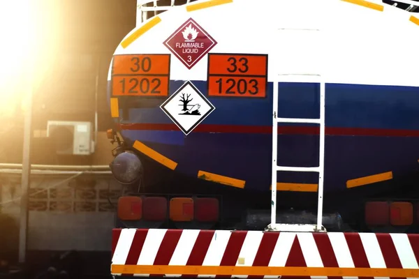 Trucks transporting dangerous chemical on the road, chemical symbols on tank