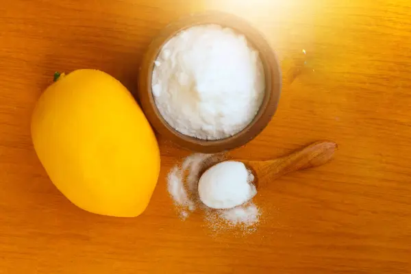 Citric acid white powder, Lemon extract is used as raw material, wood background