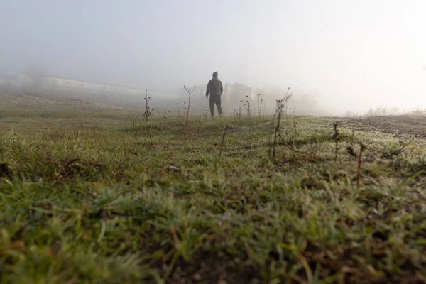 stock image Man in the foggy morning in the countryside landscape with mist