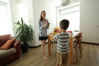 Anne ve çocuk evde oynuyorlar.