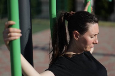 Kadın egzersiz yapıyor ya da dışarıda egzersiz yapıyor.