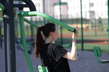 Kadın egzersiz yapıyor ya da dışarıda egzersiz yapıyor.