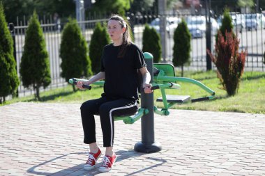 Kadın egzersiz yapıyor ya da dışarıda egzersiz yapıyor.