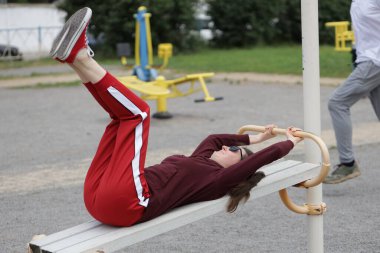 Kadın egzersiz yapıyor ya da dışarıda egzersiz yapıyor.