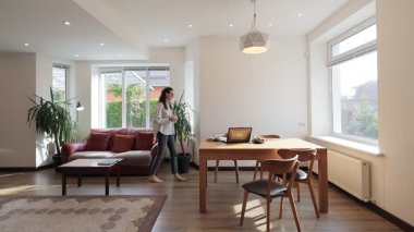 Modern bir özel evin oturma odasında bir kadın.