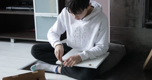 Portrait Focused Teenage Boy Wearing White Sweatshirt Black Trousers Sitting — Stockvideo