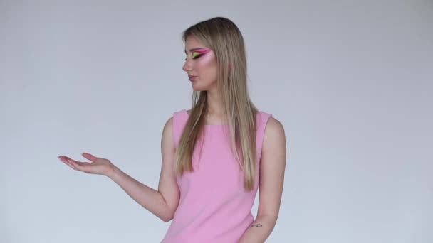 Όμορφο Μοντέλο Μόδας Νέον Μακιγιάζ Ροζ Φόρεμα Δείχνει Χέρια Της — Αρχείο Βίντεο