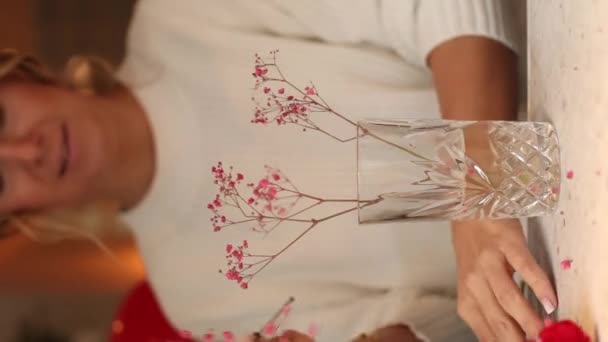 Красивая Молодая Улыбающаяся Женщина Флористка Украшает Цветочный Букет Стеклянной Вазой — стоковое видео