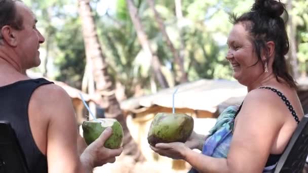 Dojrzały Mężczyzna Kobieta Relaksujący Pijący Mleko Kokosowe Słomką Owoców Kokosowych — Wideo stockowe
