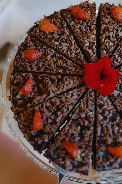 Delicious chocolate cake with strawberries and chocolate pieces. Professional baking and confectionery. Home cooking. Cakes to order. Holidays and parties. Culinary skills. Only natural ingredients.