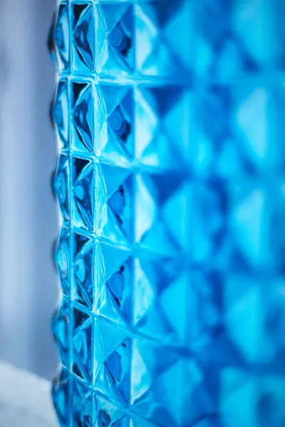 Bright blue glass wall unit. Design element. Image for layout, postcard background. Background, texture of material.Abstract image. Material for walls in bathrooms, swimming pools.