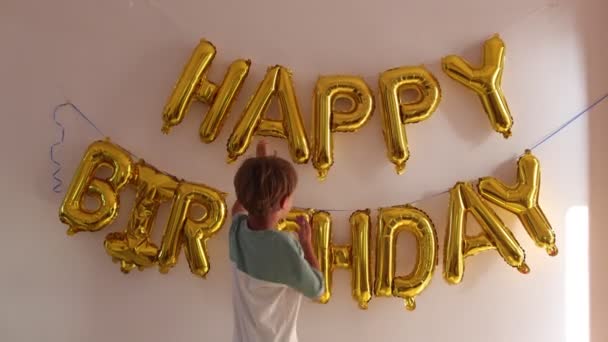 Happy Boy Looks Inscription Wall Happy Birthday Made Golden Balloons — Stock Video