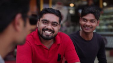 Olumlu duygular. Üç erkek arkadaş, Asya uyruklu iş ortakları kendi aralarında gülüp konuşurlar, binanın içinde otururlar. İş iletişimi. Arkadaşlarla buluşacağız. 4k görüntü