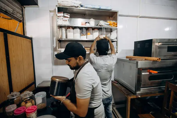 stock image Bakers ensure ingredients are wellorganized in a commercial kitchen to optimize culinary activities