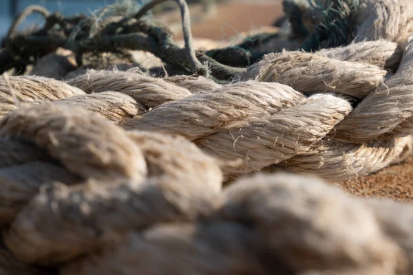 Frayed mooring ropes on fishing dock in Portugal. Close up, shallow depth of field.
