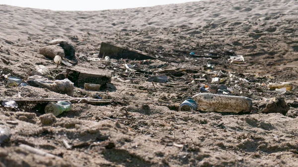 Plastic bottles and garbage on beach in Portugal. Illustrating problem of plastic pollution in oceans.