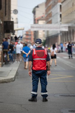 Security and Traffic Control Officer with His Paddle during an Event in a City Street.