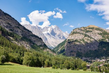 Mountain Range of the Italian Alps on a Sunny Summer Day- view of Glacier, Green Vegetation and Blue Sky.