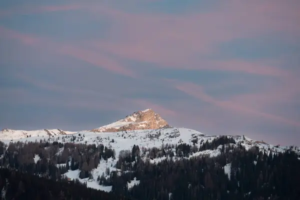 Sunset over the Mountains: Sky with Shades of Pink and Orange in Italian Dolomites Mountains Alps, Italy.