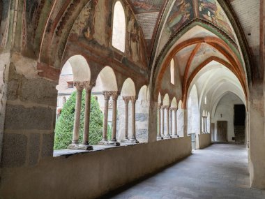 Historic Gothic Cloister Featuring Intricate Murals, Stone Arches and Frescoed Ceiling, Bressanone - Italy. clipart