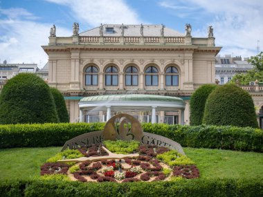 A Floral Clock and Classical Architecture: Vienna's Stadtpark, The Kursalon and its Gardens, Austria. clipart