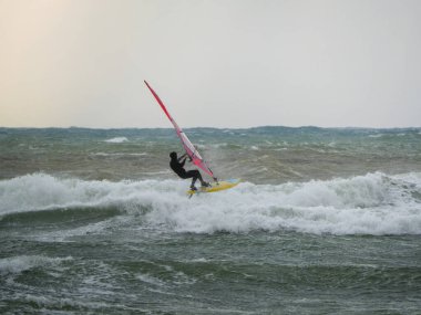 Su Sporu Aktivitesi - Rüzgârlı bir günde Dalgaya Binen Rüzgâr Sörfçüsü.