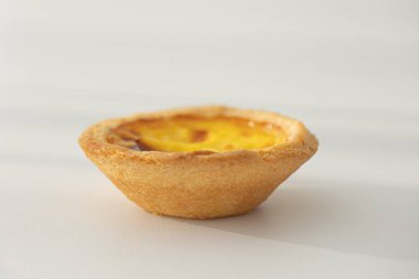 Beyaz arka planda yeni pişmiş yumurtalı tartlar.