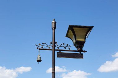 Vintage classic street lamp, sky background clipart