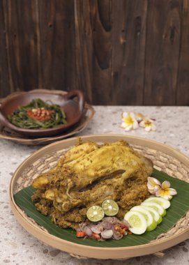 Balinese Indonesian food named Ayam Betutu. Served with traditional sambals and roasted peanuts. Top View clipart