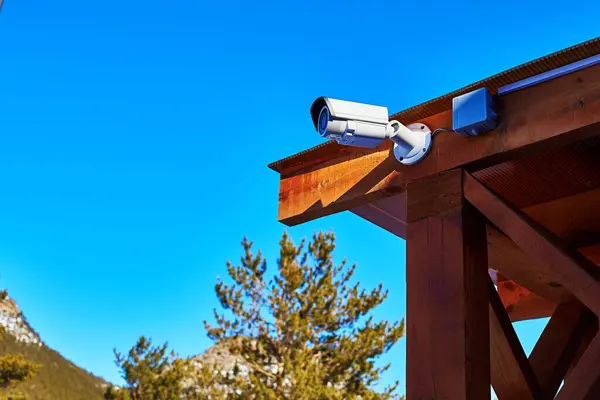 video surveillance camera mounted on a wooden canopy structure