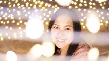 Işıklar arasında Asyalı kadının yüzüne yakın çekim.