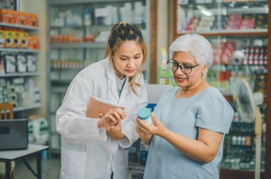 Pharmacist giving advice And advice for patients who come to buy Medicine, Drugs, Vitamins products, according to prescriptions in modern pharmacies.