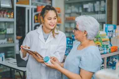 Pharmacist giving advice And advice for patients who come to buy Medicine, Drugs, Vitamins products, according to prescriptions in modern pharmacies.