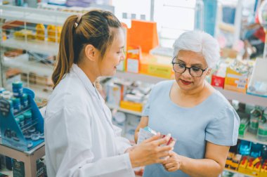 Pharmacist giving advice And advice for patients who come to buy Medicine, Drugs, Vitamins products, according to prescriptions in modern pharmacies.
