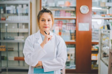 female pharmacist poses confidently welcoming, advising patients and prescription patients in a modern pharmacy.