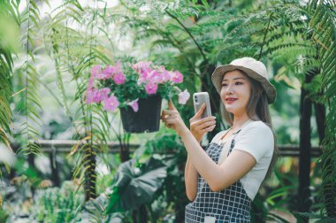 Young women doing hobbies taking care of plants, watering, shoveling flowers. In the garden during the break from work