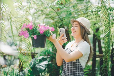 Young women doing hobbies taking care of plants, watering, shoveling flowers. In the garden during the break from work