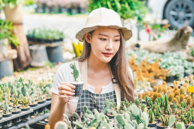 Young women doing hobbies taking care of plants, watering, shoveling flowers. In the garden during the break from work