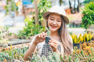 Young women doing hobbies taking care of plants, watering, shoveling flowers. In the garden during the break from work