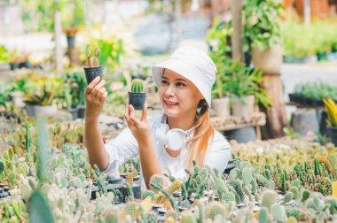Young women doing hobbies taking care of plants, watering, shoveling flowers. In the garden during the break from work