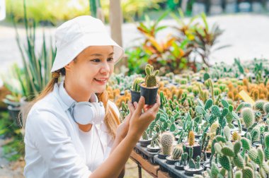 Young women doing hobbies taking care of plants, watering, shoveling flowers. In the garden during the break from work