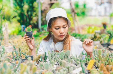 Young women doing hobbies taking care of plants, watering, shoveling flowers. In the garden during the break from work