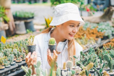 Young women doing hobbies taking care of plants, watering, shoveling flowers. In the garden during the break from work