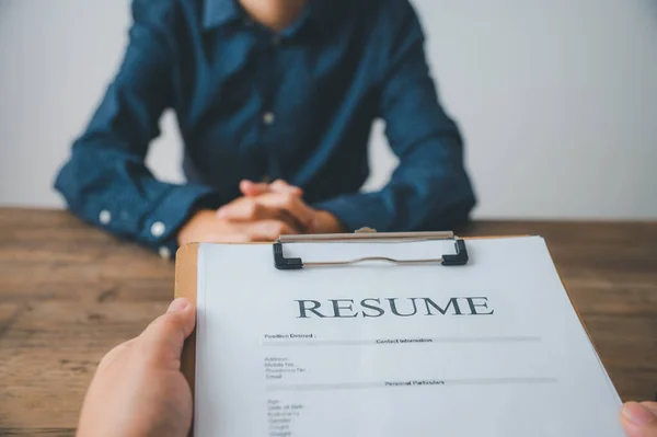 HR managers are interviewing job applicants who fill out their resume on the job application form in order to consider accepting a job as a company