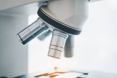 Female researchers are experimenting with pipette dropping a sample into a test tube in an experiment research in laboratory..	