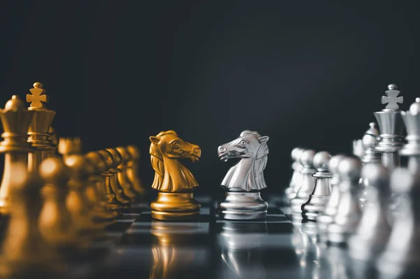 horse golden chess and horse silver chess standing face to face of the chess both teams . concepts of leadership and business strategy management and leadership
