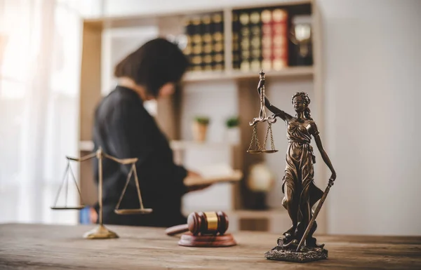 Lady Justice Holding Scales of Law in a Courtroom - Symbolizing Equality, Fairness, and Legal Proceedings