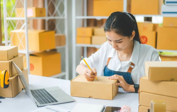 Small business owners online are writing their names and addresses to deliver products and products to their customers and check the orders  customers  - online shopping