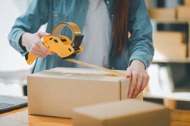 Online small business owners are packing their ordered products into the boxes for their customers based on the concept of online shopping - online shopping.