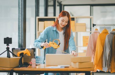Online small business owners are packing their ordered products into the boxes for their customers based on the concept of online shopping - online shopping.